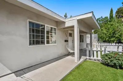 a house with a porch and a fence at Luxury on Lewis By Cardo - Jacuzzi Fire Pit in San Diego