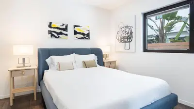 a bedroom with a large white bed and a window at Steps to BeachShops Oceanview Hot TubFirepit Moonlight Modern by AvantStay in Encinitas