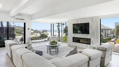 a living room with white furniture and large windows at Steps to BeachShops Oceanview Hot TubFirepit Moonlight Modern by AvantStay in Encinitas