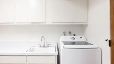 a white kitchen with a sink and a stove at Rancho Real by AvantStay Private Pool Hot Tub Luxe Group Retreat in Rancho Santa Fe