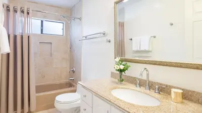 a bathroom with a sink and a toilet and a mirror at Rancho Real by AvantStay Private Pool Hot Tub Luxe Group Retreat in Rancho Santa Fe