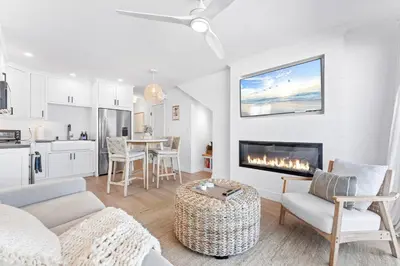 a living room with a couch and a fireplace at Luxury Ground N Oceanfront Unit with Patio Lounge in San Diego