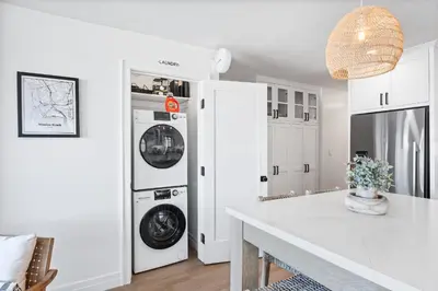 a kitchen with two washer and dryers in a room at Entire Ground Beachfront Luxury Unit with Patio in San Diego