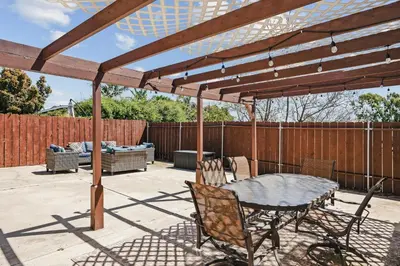 a wooden pergola with a table and chairs on a patio at Peaceful Getaway with Renovated Amenities in San Diego