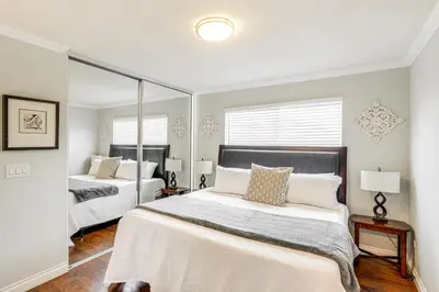 a bedroom with two beds and a mirror at Peaceful Poway Vacation Rental Near Shops and Dining in Poway