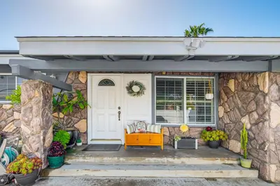 a front door of a house with a stone wall at Peaceful Poway Vacation Rental Near Shops and Dining in Poway