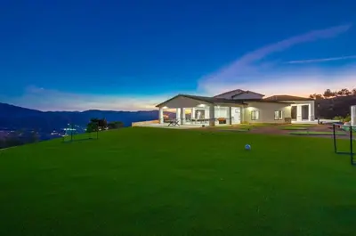 a house on a hill with a green lawn at Serene Resort-Style Escape - Perfect for Families in El Cajon