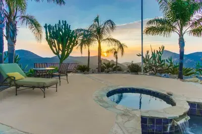 a patio with a pool and a table and chairs at Gorgeous Private Estate with Pool & Pickleball Court in Lakeside
