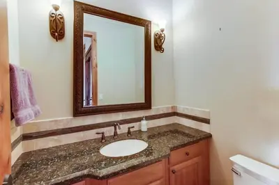 a bathroom with a sink and a mirror at Gorgeous Private Estate with Pool & Pickleball Court in Lakeside