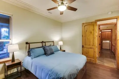 a bedroom with a bed and a ceiling fan at Gorgeous Private Estate with Pool & Pickleball Court in Lakeside