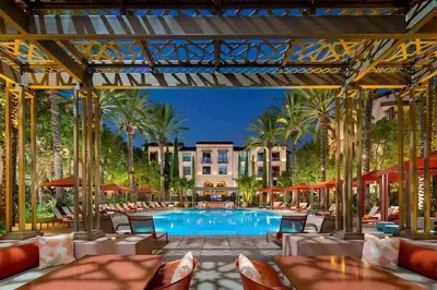 a pool at a resort with tables and chairs at 3 Bedrooms Apt with Pool ,GYM in Irvine