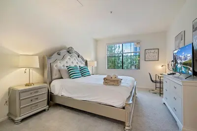 a bedroom with a bed and a flat screen tv at 3 Bedrooms Apt with Pool ,GYM in Irvine