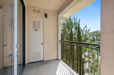 a balcony with a door and a view at 3 Bedrooms Apt with Pool ,GYM in Irvine