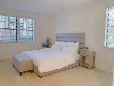 a white bedroom with a large white bed and windows at 3 Bedrooms Apt with Pool ,GYM in Irvine
