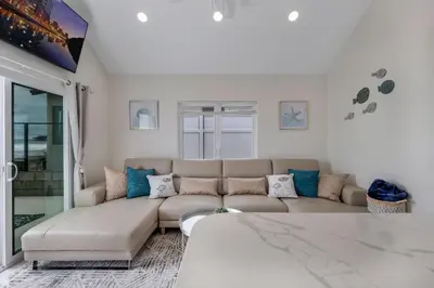 a living room with a couch and a table at The Shining Sea A in Oceanside
