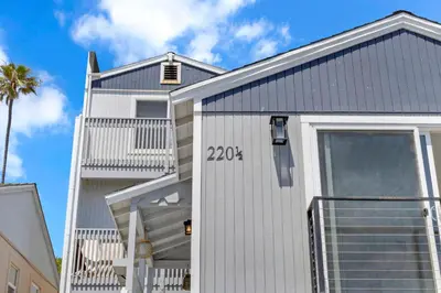 a white house with a gray roof at The Shining Sea B in Oceanside
