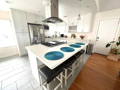 a kitchen with a counter with blue plates on it at Family Friendly Retreat with Yard and Play Area, 2000 sq ft, AC, Fiber Optic WiFi in San Diego