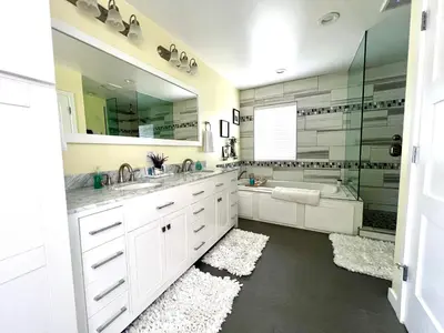a white bathroom with two sinks and a tub at Family Friendly Retreat with Yard and Play Area, 2000 sq ft, AC, Fiber Optic WiFi in San Diego