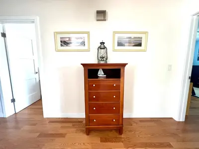 a room with a dresser and two pictures on the wall at Family Friendly Retreat with Yard and Play Area, 2000 sq ft, AC, Fiber Optic WiFi in San Diego