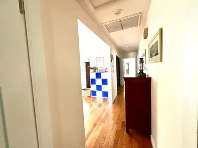 a hallway of a home with a wooden floor at Family Friendly Retreat with Yard and Play Area, 2000 sq ft, AC, Fiber Optic WiFi in San Diego