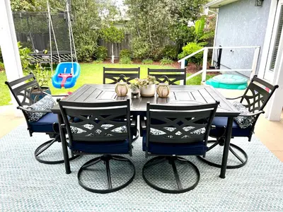 a black table with four chairs around it at Family Friendly Retreat with Yard and Play Area, 2000 sq ft, AC, Fiber Optic WiFi in San Diego