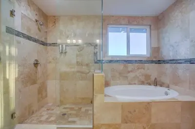 a bathroom with a tub and a window at Large Pool Home on Two Acres with Views! in Vista