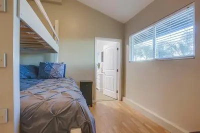 a bedroom with a bed and a window at Large Pool Home on Two Acres with Views! in Vista