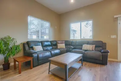 a living room with a leather couch and a coffee table at Large Pool Home on Two Acres with Views! in Vista
