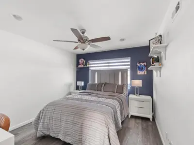 a bedroom with a bed and a ceiling fan at Super Spacious Family Vacation House! in San Diego