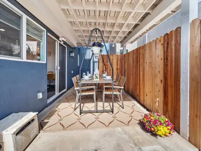 a patio with a table and chairs and a fence at Super Spacious Family Vacation House! in San Diego