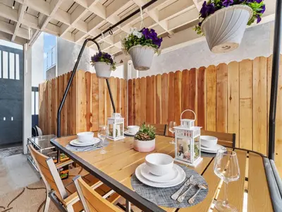 a dining room with a table and chairs and a wooden wall at Super Spacious Family Vacation House! in San Diego
