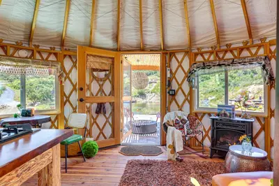 a living room with a fireplace in a yurt at Mystical Mongolian Yurt in Fallbrook with Views! in Temecula