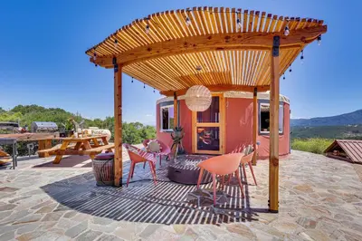 a pergola on a patio with chairs and a table at Mystical Mongolian Yurt in Fallbrook with Views! in Temecula