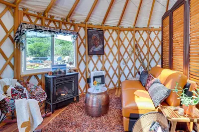 a room with a couch and a stove in a yurt at Mystical Mongolian Yurt in Fallbrook with Views! in Temecula
