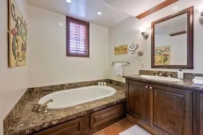 a bathroom with a tub and two sinks at Heated Pool & Hot Tub Access, Walk 2 Omni Resort, Free Parking, Wi-Fi, Washer & Dryer in Encinitas