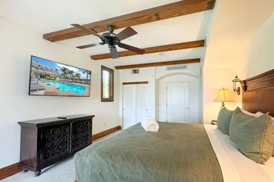 a bedroom with a bed and a ceiling fan at Heated Pool & Hot Tub Access, Walk 2 Omni Resort, Free Parking, Wi-Fi, Washer & Dryer in Encinitas