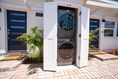 a washing machine in the doorway of a house at La Jolla Windansea Luxury Apt in San Diego