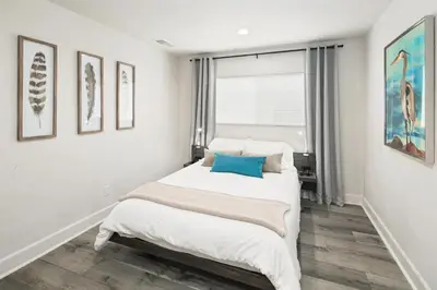 a white bedroom with a bed and a window at Modern 1 BR Apt - Walk to Ocean & Cafes in San Diego