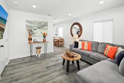 a living room with a couch and a table at Modern 1 BR Beach Waves and Sunshine in San Diego