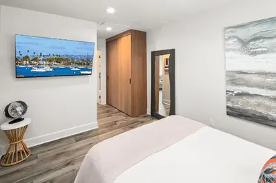 a bedroom with a bed and a painting on the wall at Modern 1 BR Beach Waves and Sunshine in San Diego