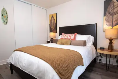 a bedroom with a large bed and two lamps at 5BD Family, Event Friendly 4plex Steps2Beach in San Diego
