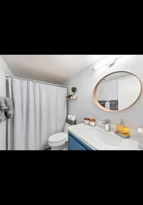 a bathroom with a sink and a toilet and a mirror at Golden Gateaway in Dana Point