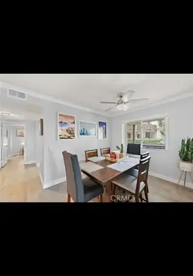 a living room with a dining room table and chairs at Golden Gateaway in Dana Point