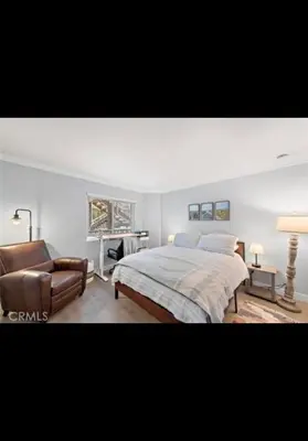 a bedroom with a bed and a couch and a chair at Golden Gateaway in Dana Point