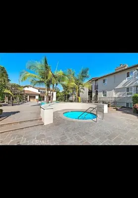 a swimming pool in a yard with palm trees at Golden Gateaway in Dana Point