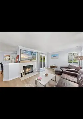 a living room with a couch and a fireplace at Golden Gateaway in Dana Point