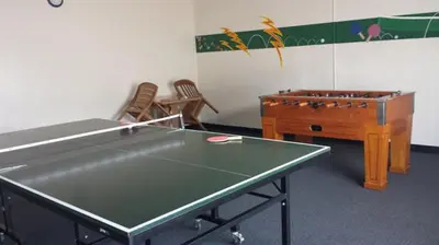 a room with a ping pong table and a desk at Sand Pebbles Resort - Amazing 2 Bedroom Condo Right by the Beaches & Attractions in Solana Beach