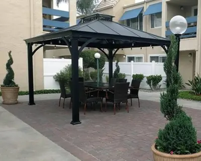 a black gazebo with a table and chairs at Sand Pebbles Resort - Amazing 2 Bedroom Condo Right by the Beaches & Attractions in Solana Beach