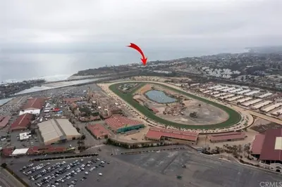 a red kite flying over a city with the ocean at Sand Pebbles Resort - Amazing 2 Bedroom Condo Right by the Beaches & Attractions in Solana Beach
