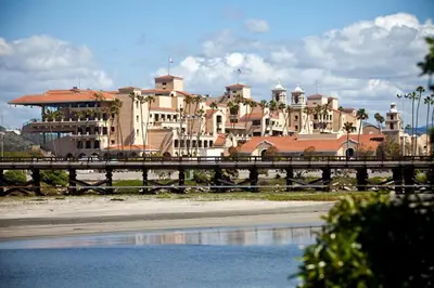 a bridge over a body of water with buildings in the background at Sand Pebbles Resort - Amazing 2 Bedroom Condo Right by the Beaches & Attractions in Solana Beach
